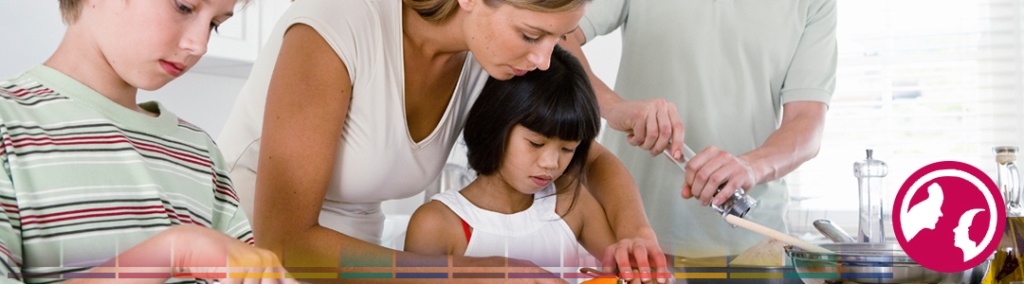 Woman helping child prepare meal.