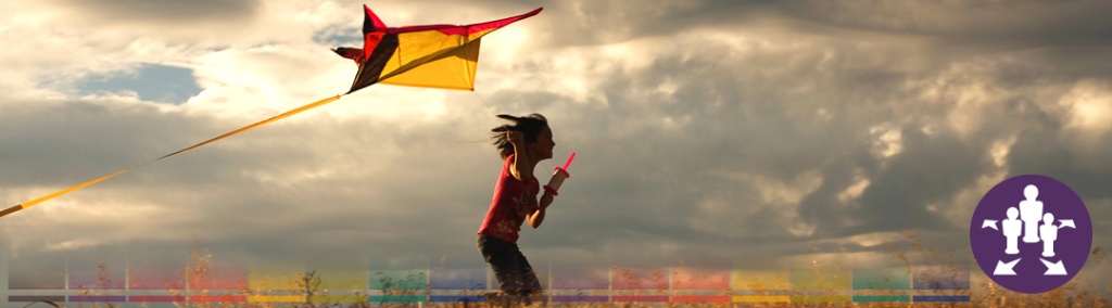 Picture of a girl flying a kite.