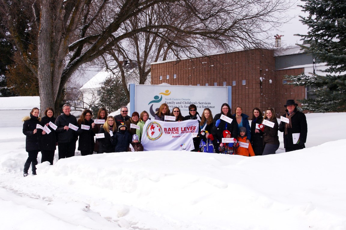 Group of peple with flag outside